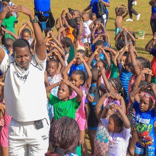 Coach leading a kids fitness session